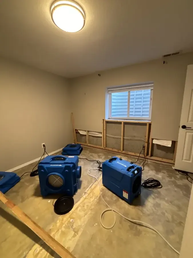 Air movers drying a room after a leak