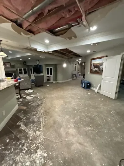 An opened ceiling with drying equipment underneath