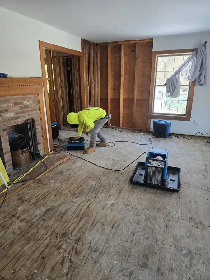 Flooring pulled up and air movers drying the bare floor