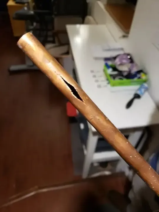 A copper supply pipe split open where it burst